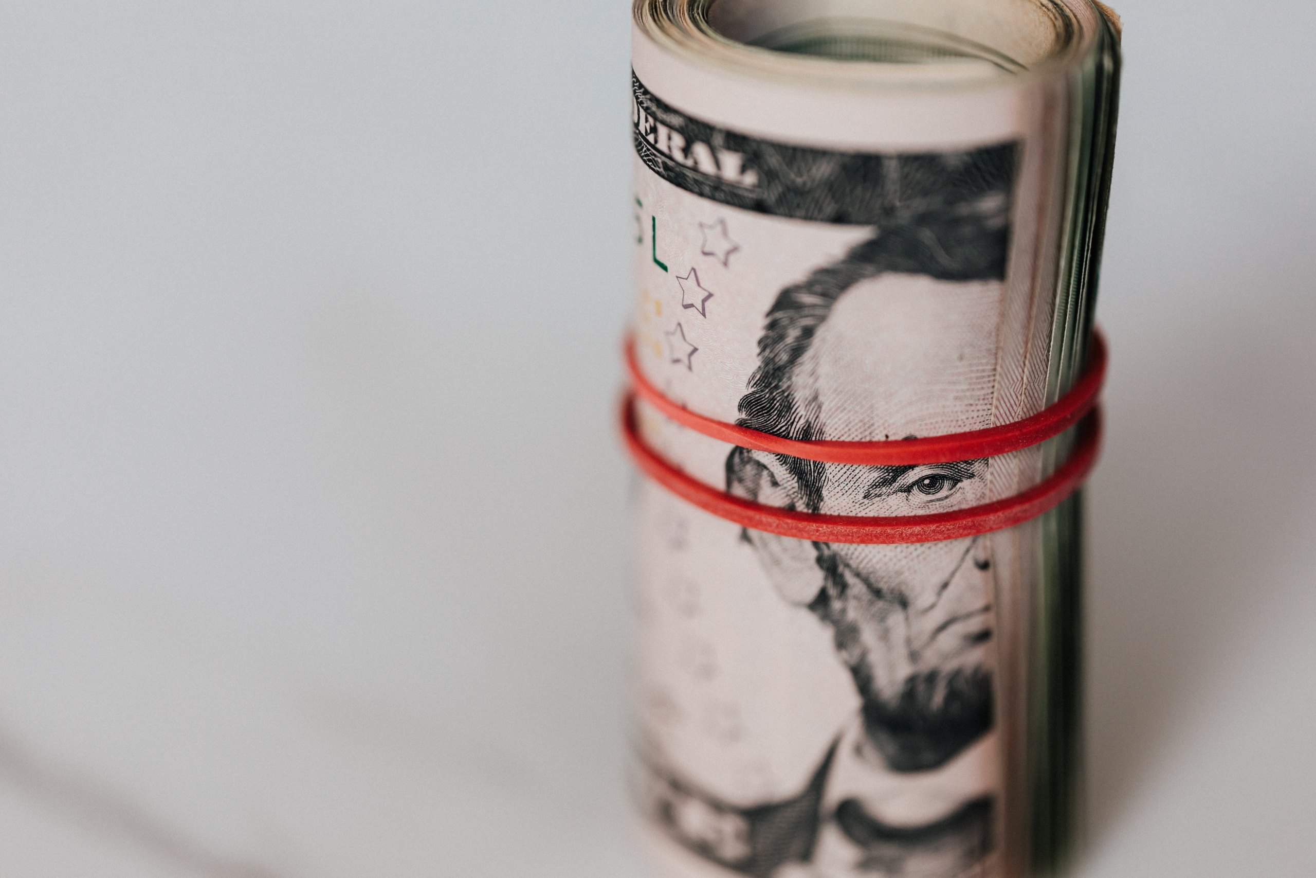 Photo by Karolina Grabowska: https://www.pexels.com/photo/roll-of-american-dollars-tightened-with-red-band-4386471/